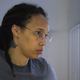 Brittney Griner, who was detained at Moscow’s Sheremetyevo airport and later charged with illegal possession of cannabis, waits for the verdict inside a defendants’ cage during a hearing in Khimki outside Moscow, on August 4, 2022. (Photo by EVGENIA NOVOZHENINA / POOL / AFP) (Photo by EVGENIA NOVOZHENINA/POOL/AFP via Getty Images)